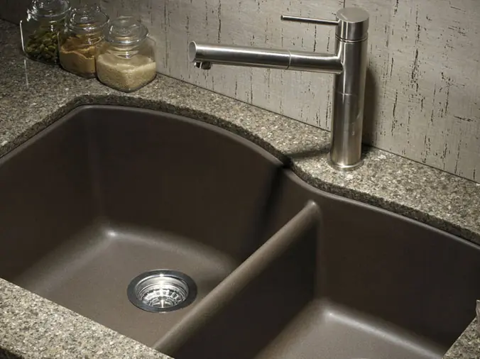 dark double kitchen sink with brushed stailess kitchen sink faucet and marble countertop